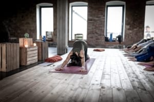 woman in dog pose in a yoga studio