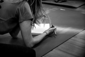 Woman completing her yoga teacher training application.