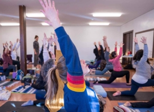 Students do yoga pose at a yoga event.